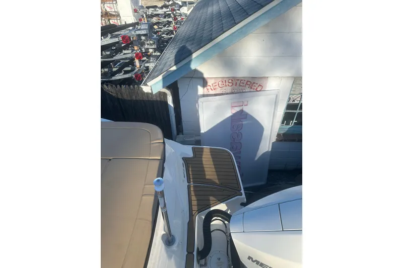 Slide: The Image of 2023 Sea Ray SPX 230 Outboard boat near a registration building. - 18
