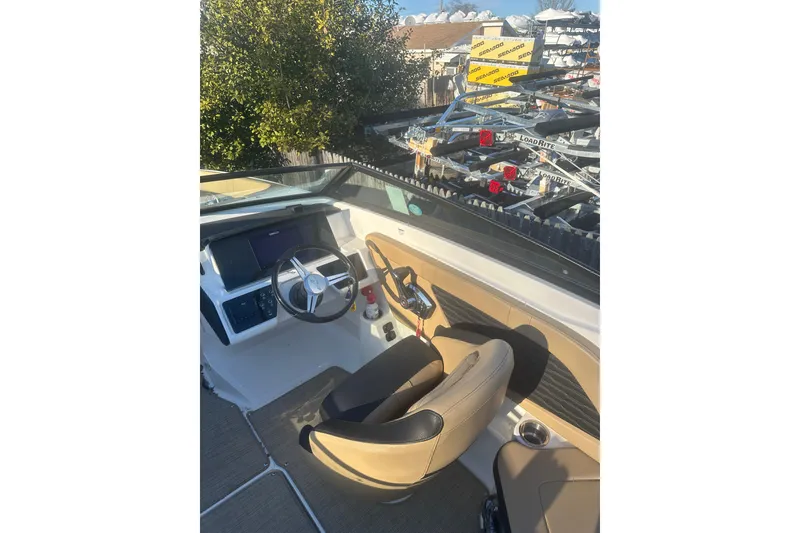 Slide: The Image of 2023 Sea Ray SPX 230 Outboard boat cockpit with steering wheel and controls. - 20