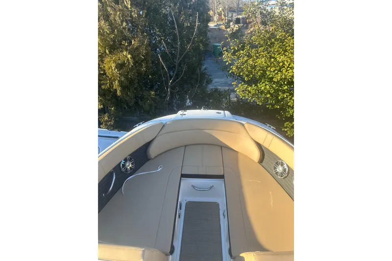Slide: The Image of 2023 Sea Ray SPX 230 Outboard boat interior with tan seating and speakers. - 23