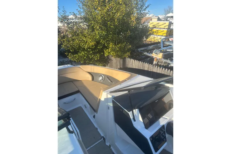 Slide: The Image of 2023 Sea Ray SPX 230 Outboard boat with tan seating and sleek dashboard design. - 24