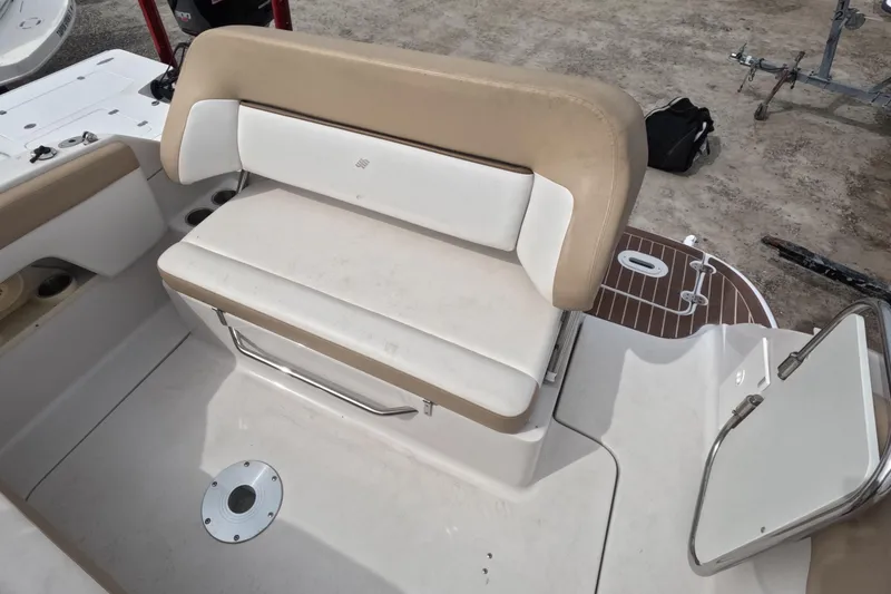 Slide: The Image of 2012 Four Winns V265 boat interior seating with beige and white upholstery. - 26