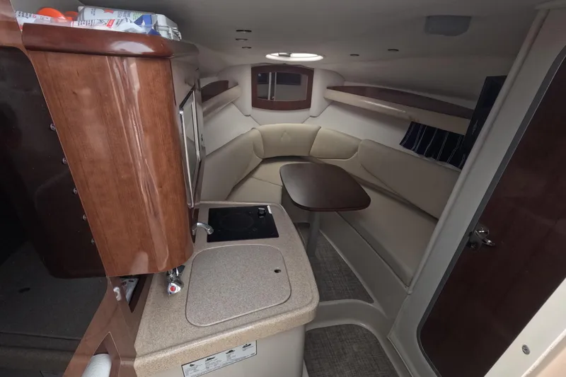 Slide: The Image of Interior of 2012 Four Winns V265 boat with seating, table, and kitchenette. - 42