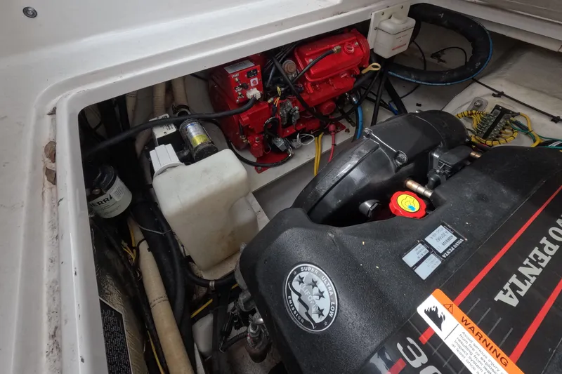 Slide: The Image of Engine compartment of 2012 Four Winns V265 boat, featuring Volvo Penta components. - 69