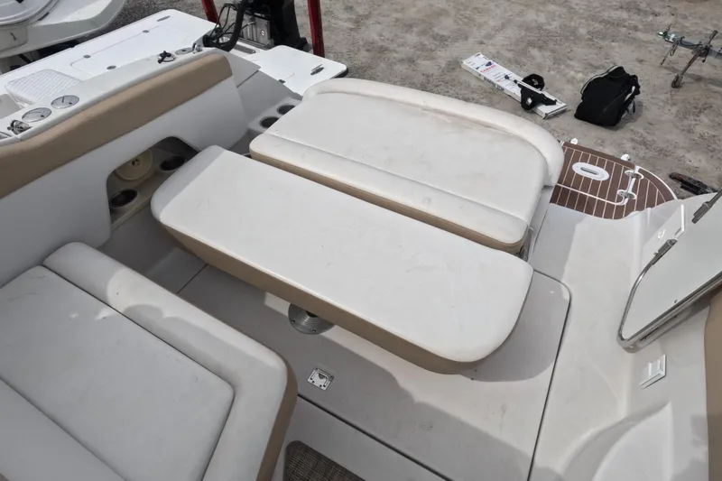 Slide: The Image of 2012 Four Winns V265 boat interior with beige seating and storage compartments. - 74