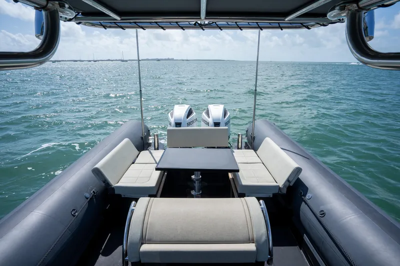Slide: The Image of 2023 Sea Water PHANTOM 280 boat interior with seating, table, and ocean view. - 10