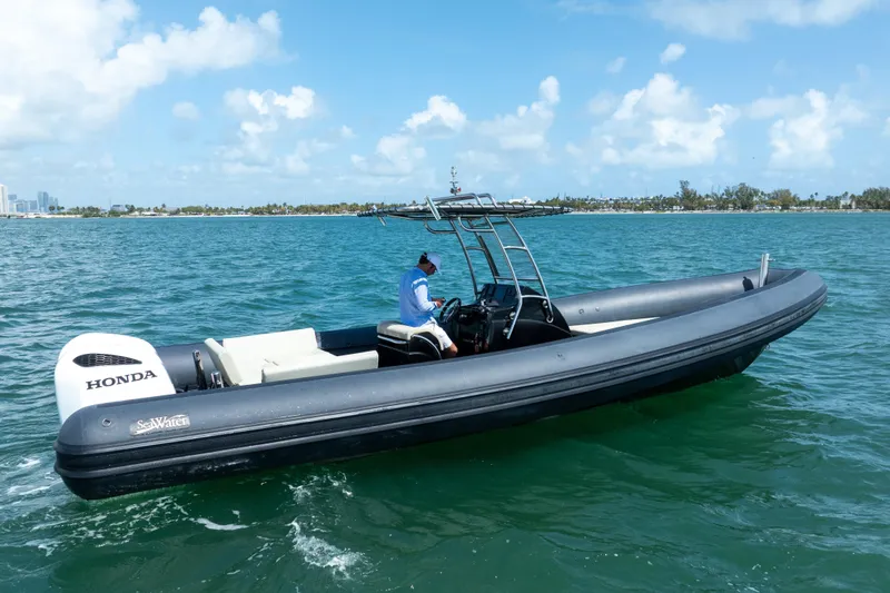 Slide: The Image of 2023 Sea Water PHANTOM 280 boat cruising on clear blue water under a sunny sky. - 2