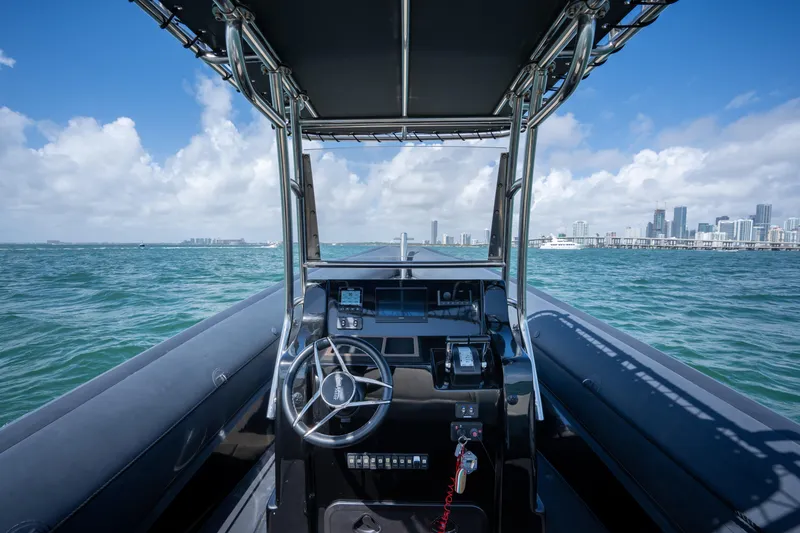 Slide: The Image of 2023 Sea Water PHANTOM 280 boat navigating ocean with city skyline in background. - 25