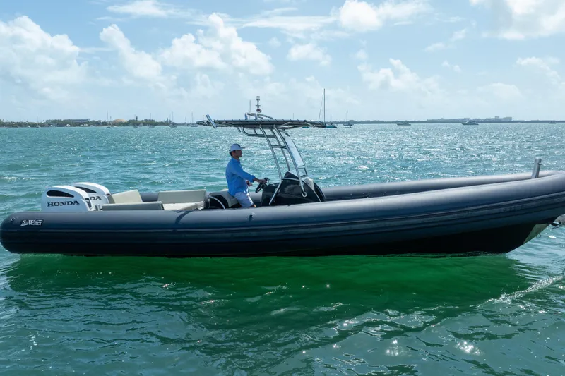 Slide: The Image of 2023 Sea Water PHANTOM 280 boat on ocean with person steering, under clear sky. - 3