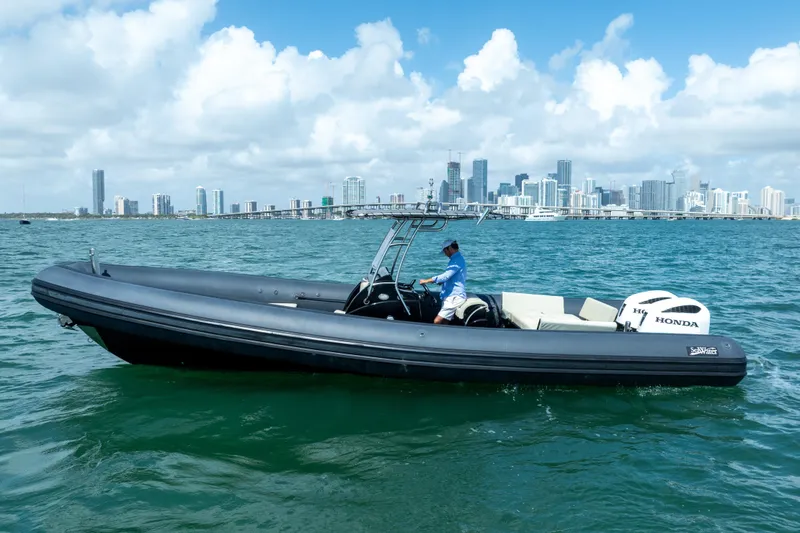 Slide: The Image of 2023 Sea Water PHANTOM 280 boat cruising near city skyline on a sunny day. - 6