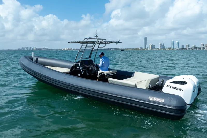 Slide: The Image of 2023 Sea Water PHANTOM 280 boat cruising on ocean with city skyline in background. - 7