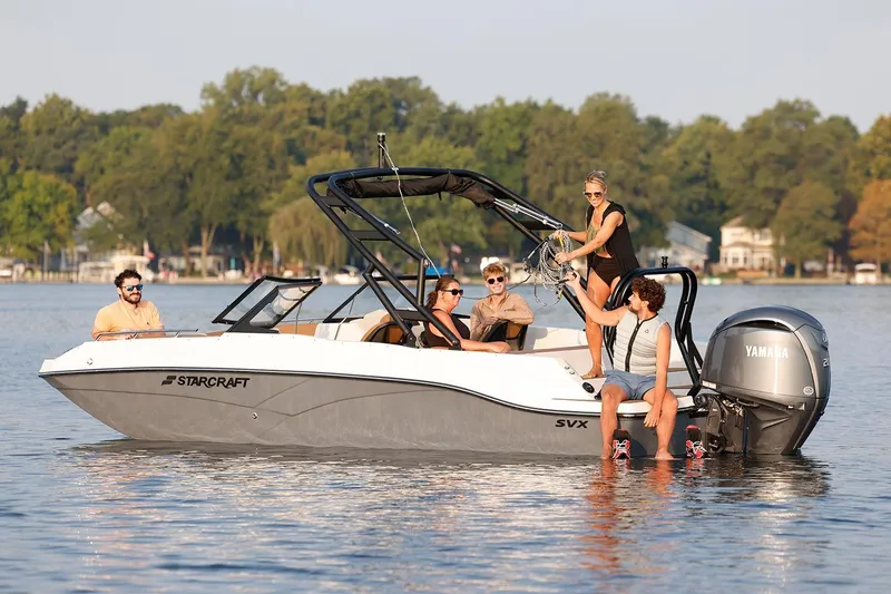 Slide: The Image of 2026 Starcraft SVX 210 DC OB boat with Suzuki outboard motor at a boat show. - 12