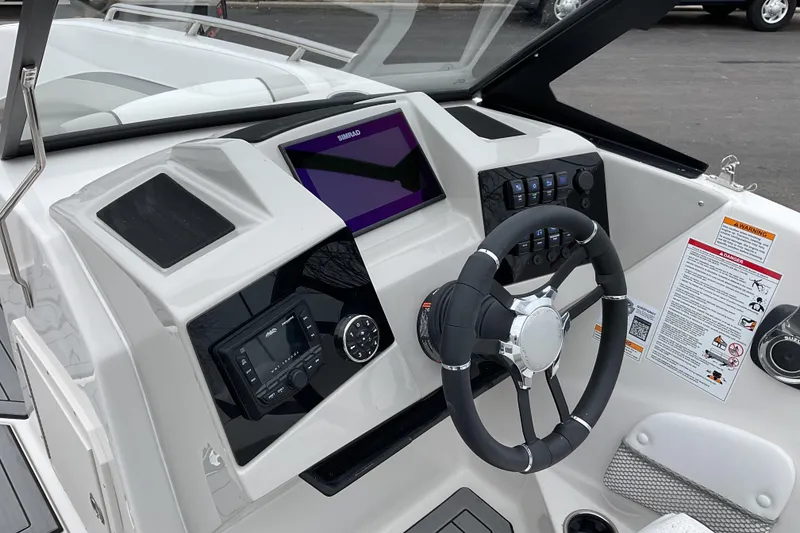 Slide: The Image of 2026 Starcraft SVX 210 DC OB boat displayed at an indoor exhibition. - 2