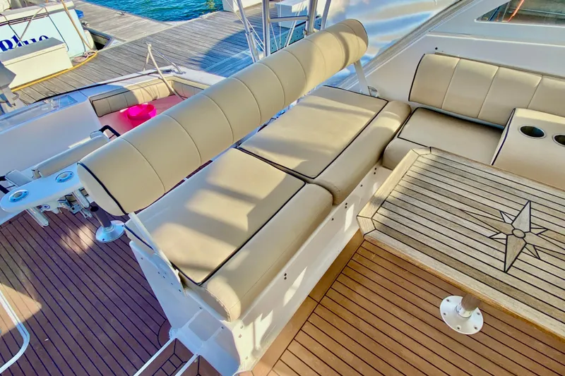 Slide: The Image of Luxurious seating area on 2006 Luhrs 41 Open yacht with teak flooring and nautical-themed table. - 14