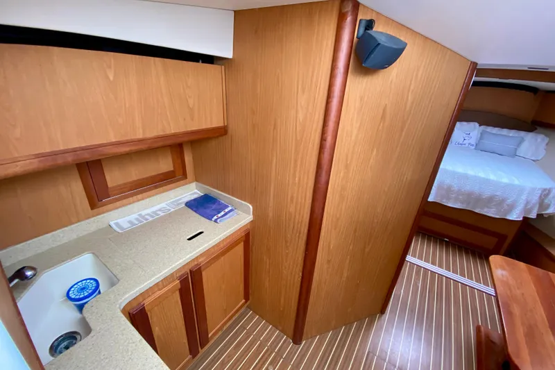 Slide: The Image of 2006 Luhrs 41 Open yacht interior with wood cabinetry and cozy sleeping area. - 19