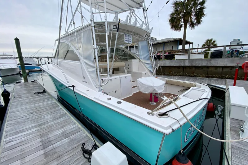 Slide: The Image of 2006 Luhrs 41 Open yacht docked, featuring a spacious deck and sleek design. - 2