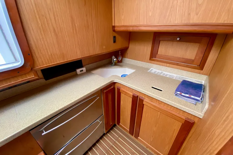 Slide: The Image of 2006 Luhrs 41 Open yacht kitchen with wood cabinetry and modern appliances. - 20