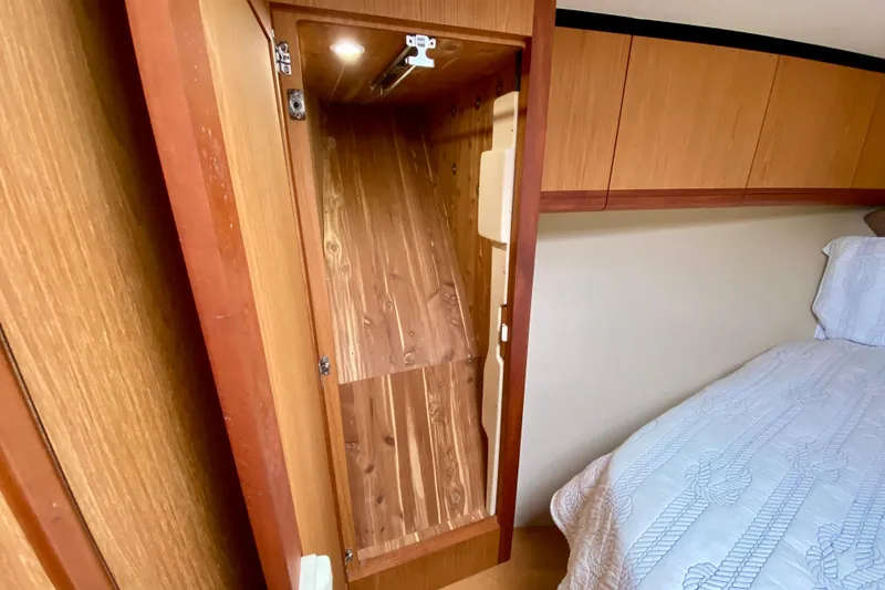 Slide: The Image of Interior of 2006 Luhrs 41 Open yacht showing wooden closet and bed. - 27