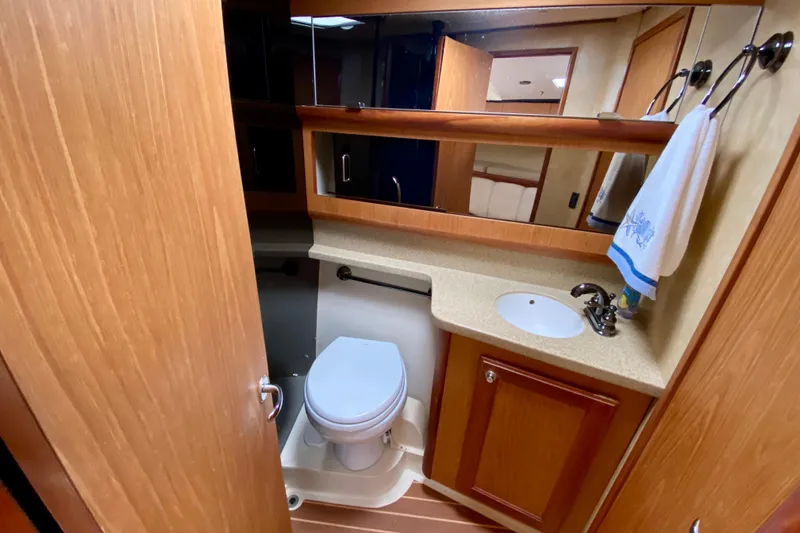 Slide: The Image of Bathroom interior of 2006 Luhrs 41 Open yacht with wooden cabinetry and modern fixtures. - 28