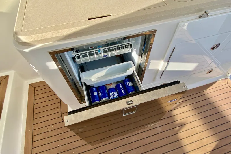 Slide: The Image of 2006 Luhrs 41 Open boat with open drawer fridge, stocked with Bud Light cans. - 31