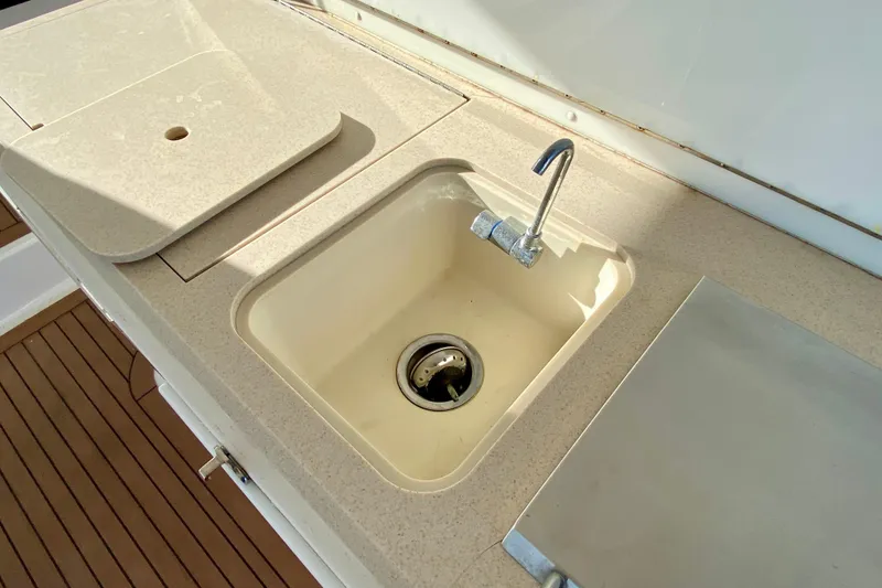 Slide: The Image of 2006 Luhrs 41 Open yacht sink with beige countertop and wooden flooring. - 33