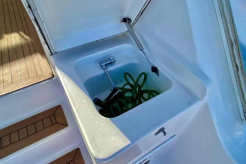 Slide: The Image of Storage compartment on 2006 Luhrs 41 Open boat with hose and tools. - 34