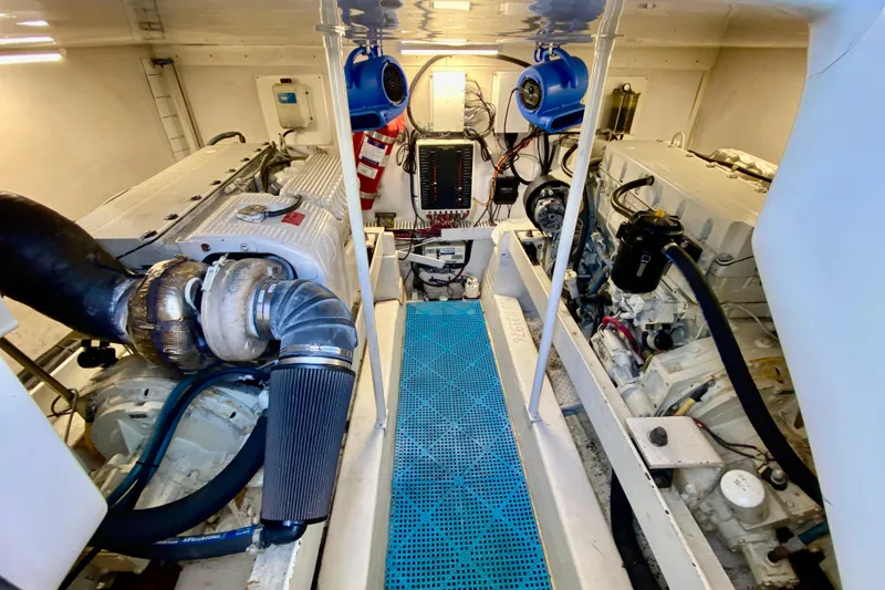 Slide: The Image of Engine room of 2006 Luhrs 41 Open boat, featuring dual engines and blue flooring. - 38
