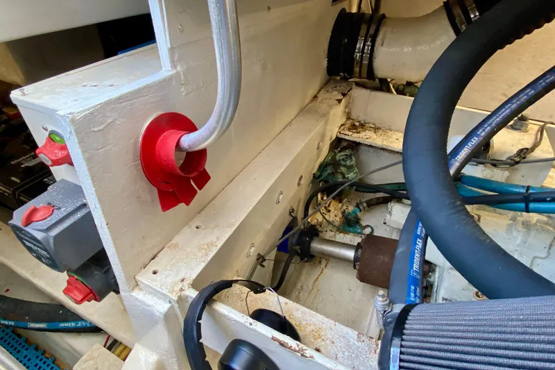 Slide: The Image of Engine compartment of a 2006 Luhrs 41 Open boat, showing mechanical components and hoses. - 45