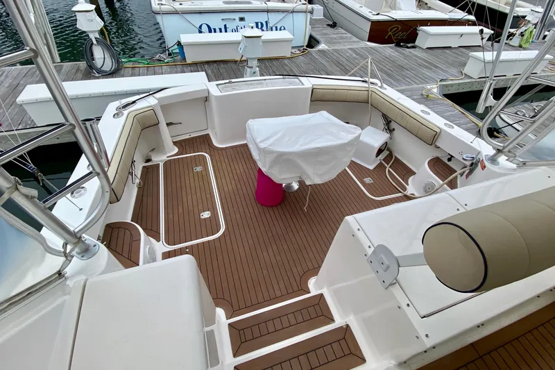 Slide: The Image of 2006 Luhrs 41 Open boat deck with teak flooring and cushioned seating. - 8