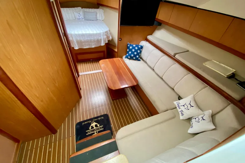 Slide: The Image of 2006 Luhrs 41 Open boat deck with teak flooring and outboard motor. - 9