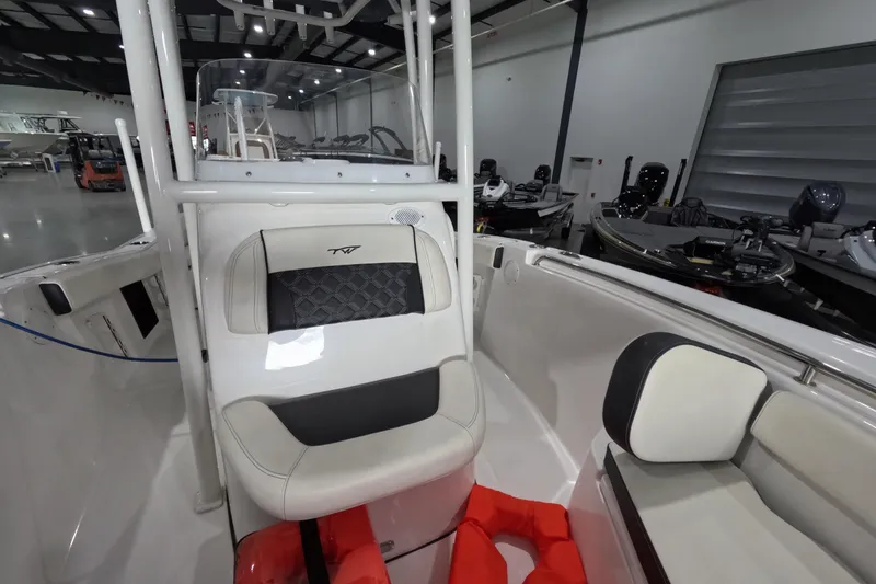 Slide: The Image of 2022 Tidewater boat interior with cushioned seating and life jackets in a showroom. - 13