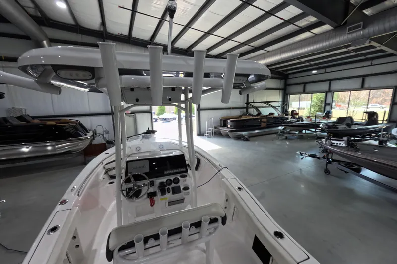 Slide: The Image of 2022 Tidewater boat in showroom with modern interior and multiple vessels displayed. - 14