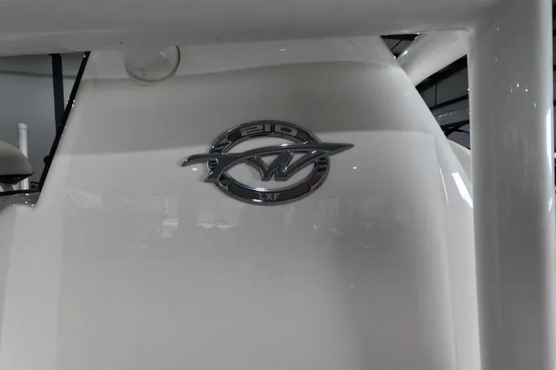 Slide: The Image of 2022 Tidewater boat emblem on white surface, featuring the 210 LXF model logo. - 18