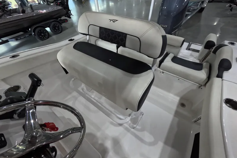 Slide: The Image of 2022 Tidewater boat interior with cushioned seating and steering wheel in showroom. - 6
