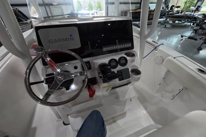 Slide: The Image of 2022 Tidewater boat console with Garmin navigation, steering wheel, and control panel. - 7