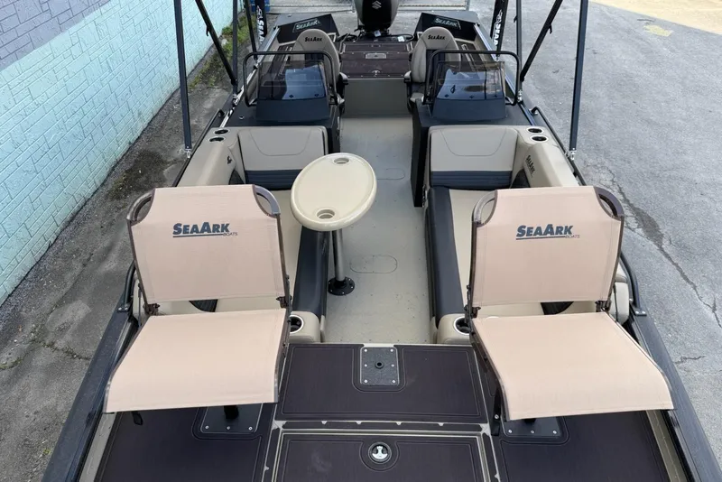 Slide: The Image of 2026 SeaArk Big Easy boat interior with seating and table, showcasing spacious design. - 10