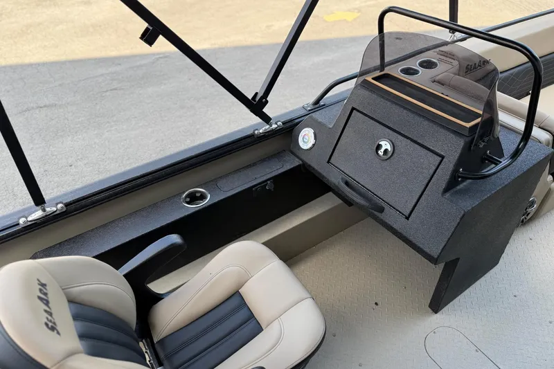 Slide: The Image of 2026 SeaArk Big Easy boat interior with steering console and comfortable seating. - 13