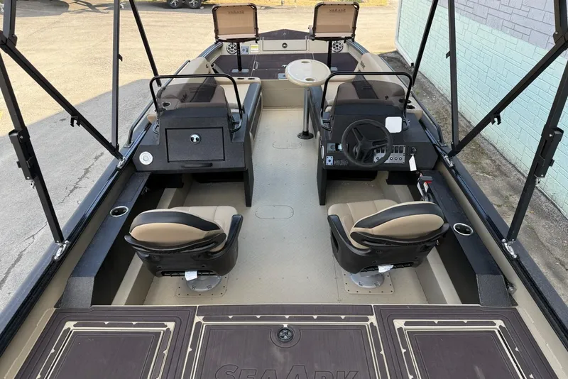 Slide: The Image of 2026 SeaArk Big Easy boat interior with dual seats and steering console. - 14