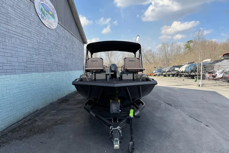 Slide: The Image of 2026 SeaArk Big Easy boat parked outside Water Works Marine under a cloudy sky. - 3
