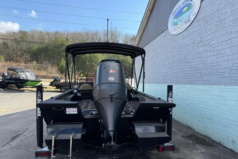 Slide: The Image of 2026 SeaArk Big Easy boat with powerful engine, parked outside Water World Marine. - 6