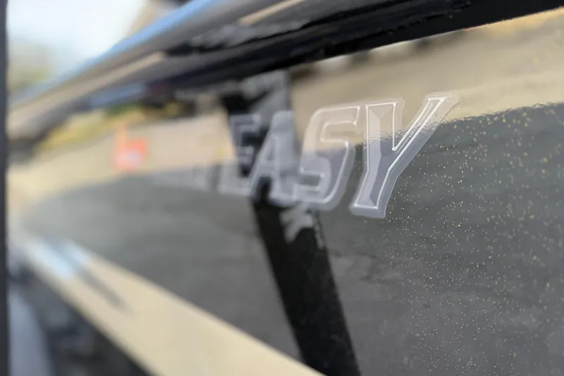 Slide: The Image of 2026 SeaArk Big Easy boat close-up with logo on sleek black surface. - 7