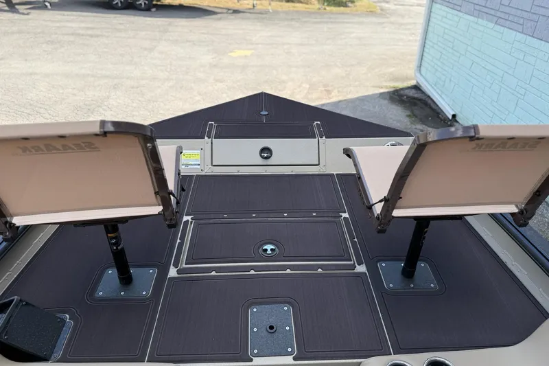 Slide: The Image of 2026 SeaArk Big Easy boat deck with dual seats and storage compartments. - 9