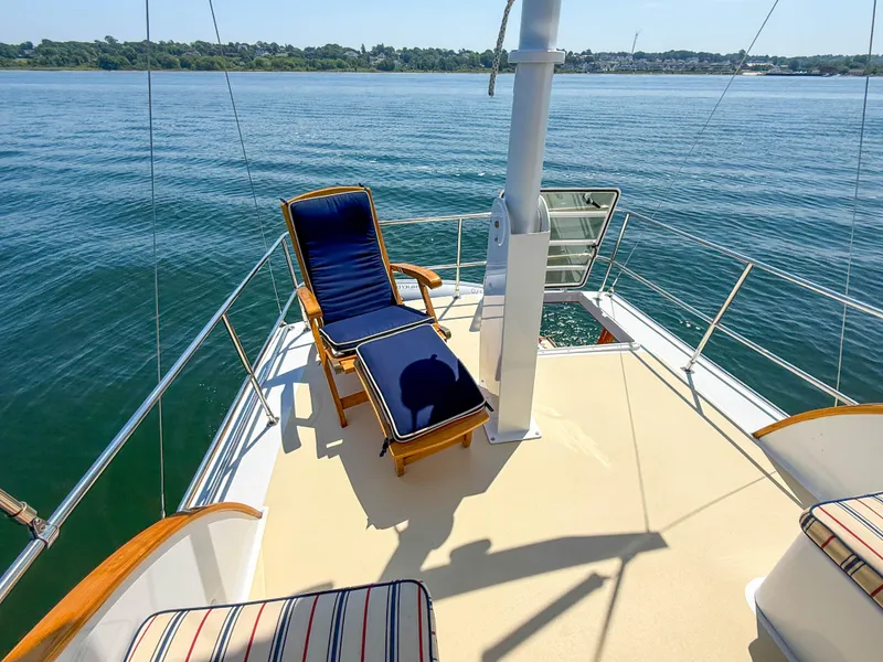 Slide: The Image of Sunny deck of 1984 Wilbur 38 yacht with lounge chairs overlooking calm waters. - 12