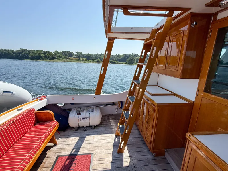 Slide: The Image of Interior of 1984 Wilbur 38 boat with wooden cabinetry and outdoor seating. - 15