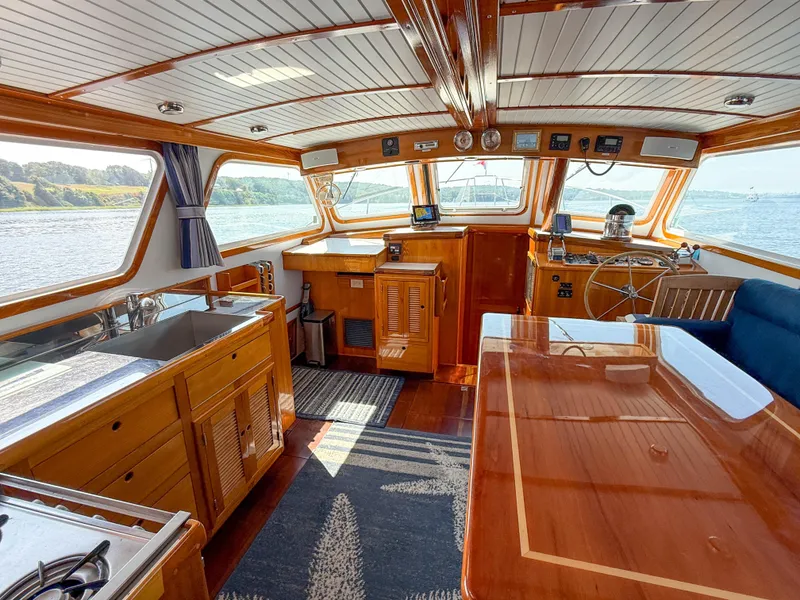 Slide: The Image of Interior of 1984 Wilbur 38 boat with wooden finishes and scenic water view. - 18