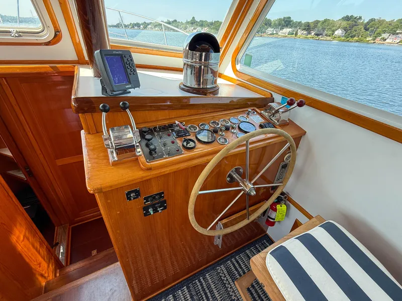 Slide: The Image of Helm of 1984 Wilbur 38 boat with steering wheel, gauges, and navigation equipment. - 24
