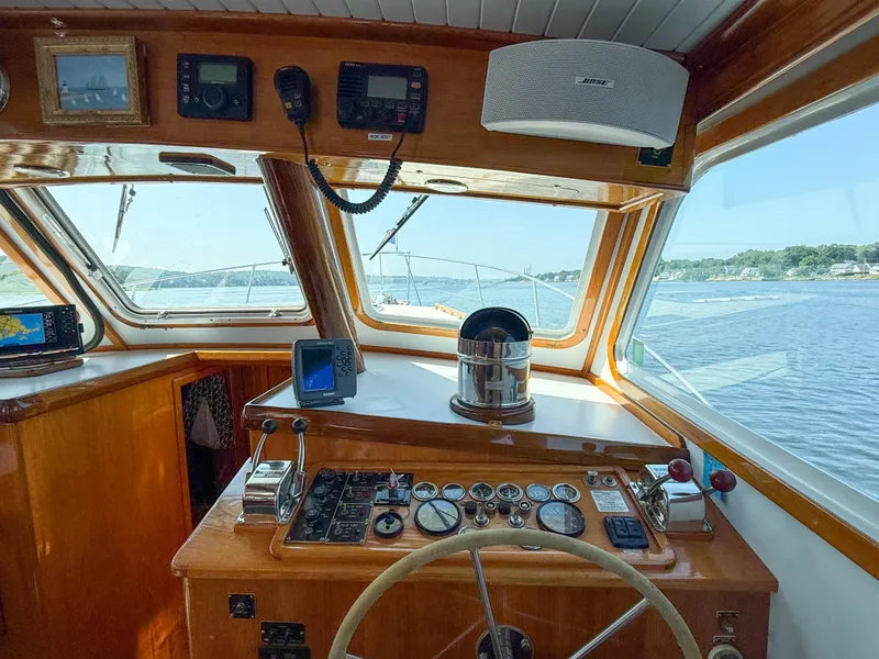 Slide: The Image of Helm of 1984 Wilbur 38 boat with navigation instruments and scenic water view. - 25