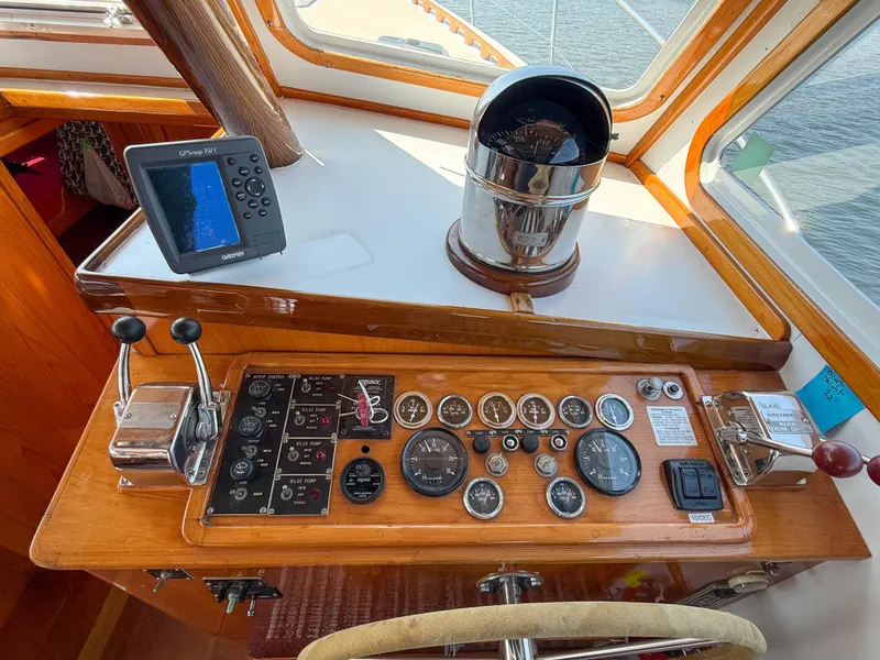 Slide: The Image of Control panel of a 1984 Wilbur 38 boat with gauges and navigation equipment. - 26