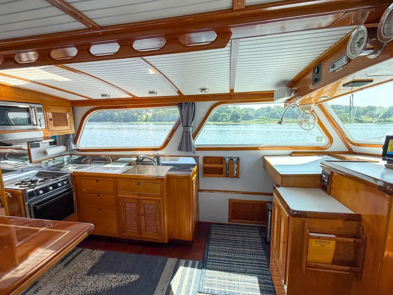 Slide: The Image of Interior of 1984 Wilbur 38 boat with wooden cabinetry and scenic water view. - 27