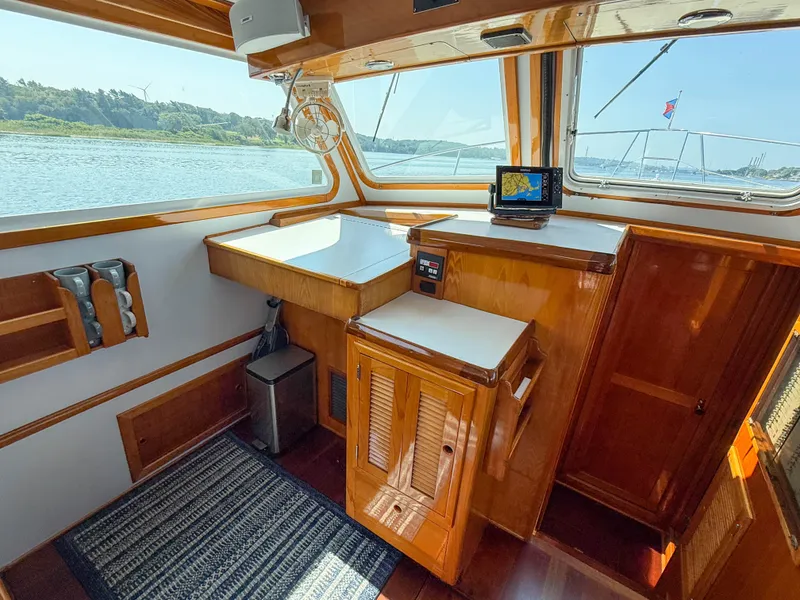 Slide: The Image of Interior of 1984 Wilbur 38 boat with wooden cabinetry and navigation equipment. - 28