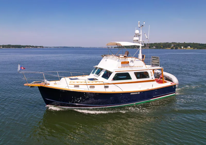 Slide: The Image of 1984 Wilbur 38 boat cruising on calm waters under clear blue sky. - 3